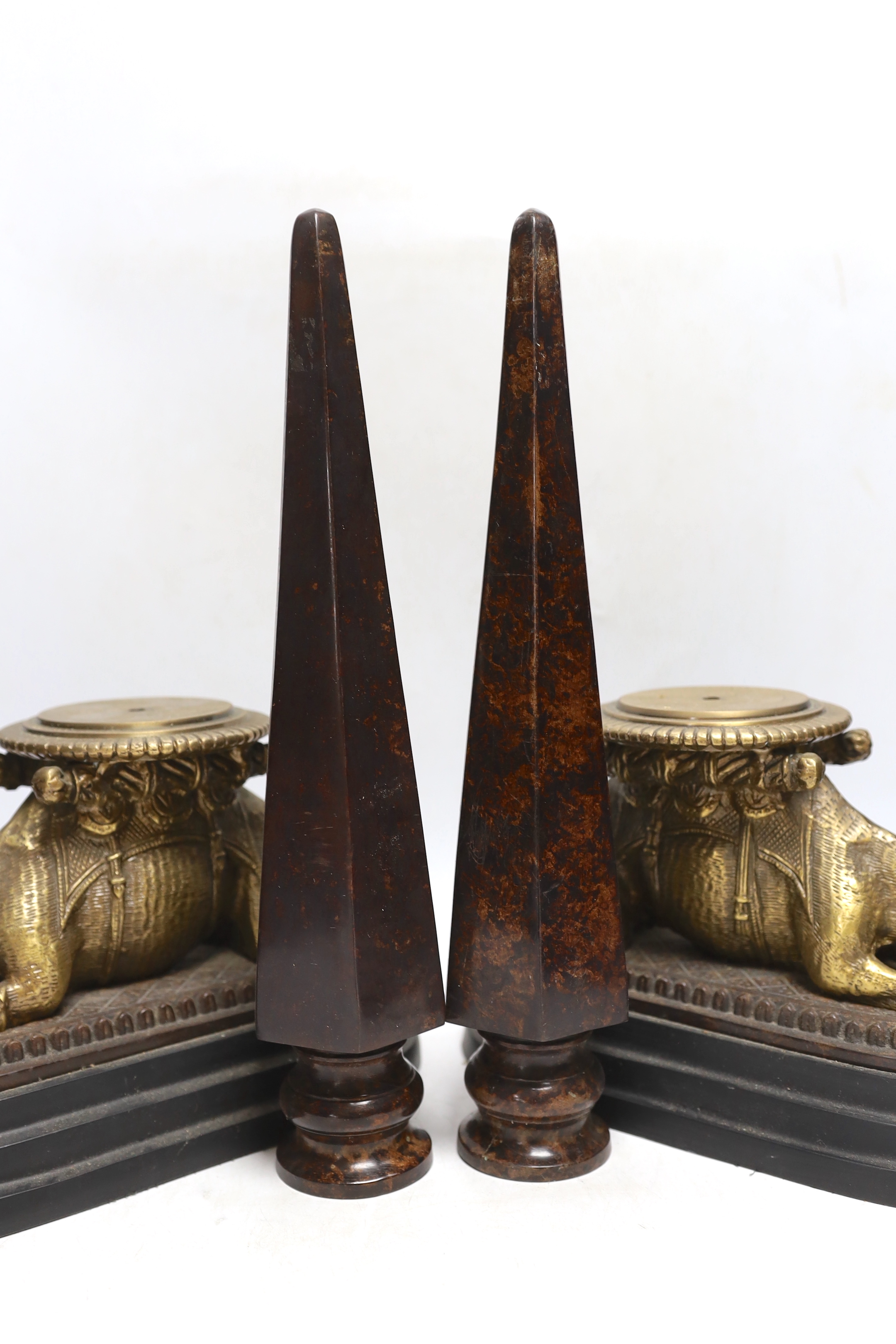 A pair of camel and obelisk side ornaments raised on tapered bases, 51cm high